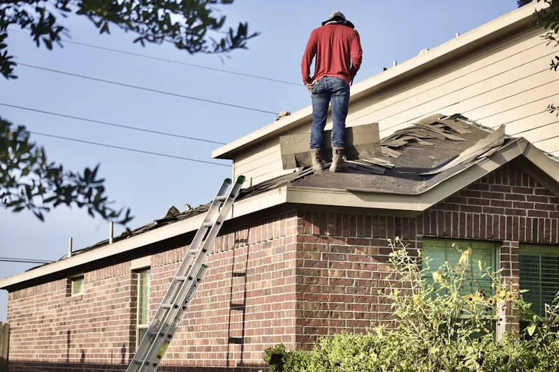 Professional roofer working on a residential roof in Sterling Heights